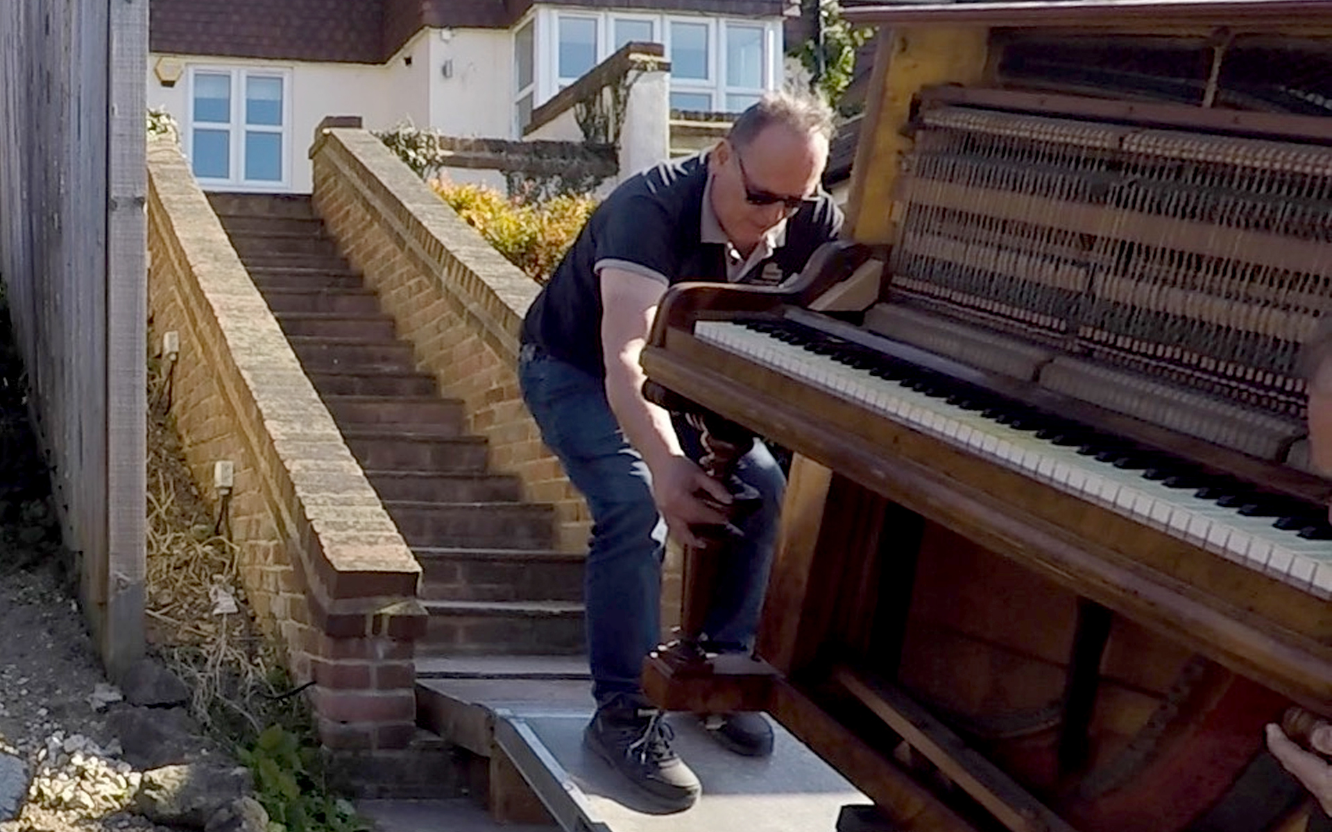 Moving a heavy piano up steep steps