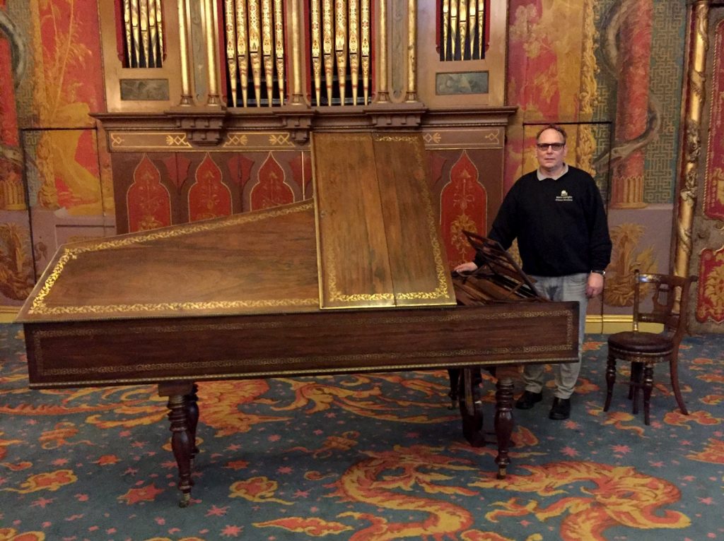 Chris by antique piano in Brighton Pavilion