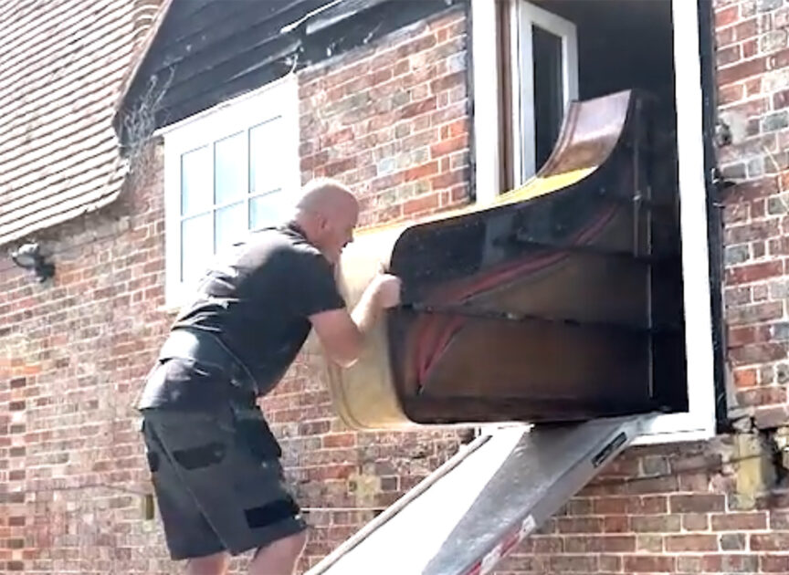 Tight-Rope Piano Disposal From Window Brick House